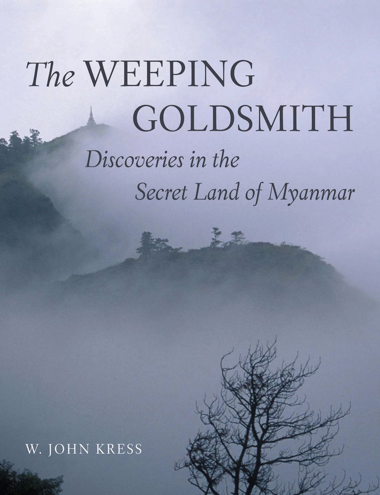 Book cover of The Weeping Goldsmith: Discoveries in the Secret Land of Myanmar, with misty mountain landscape of Myanmar. Published by Abbeville Press.