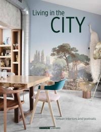 Interior dining space, landscape mural on wall, industrial silver flue in corner, on cover of 'Living in the City, Urban Interiors and Portraits', by Lannoo Publishers.