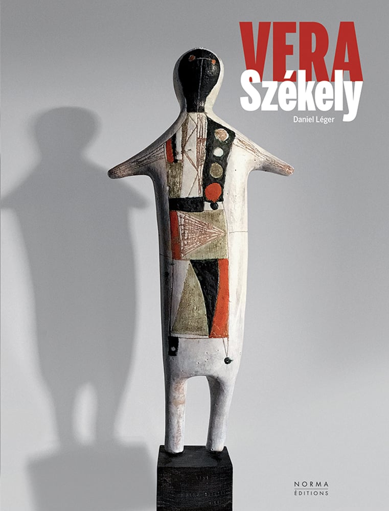 Abstract ceramic figure on black plinth, grey cover, VERA Székely in red and white font above.