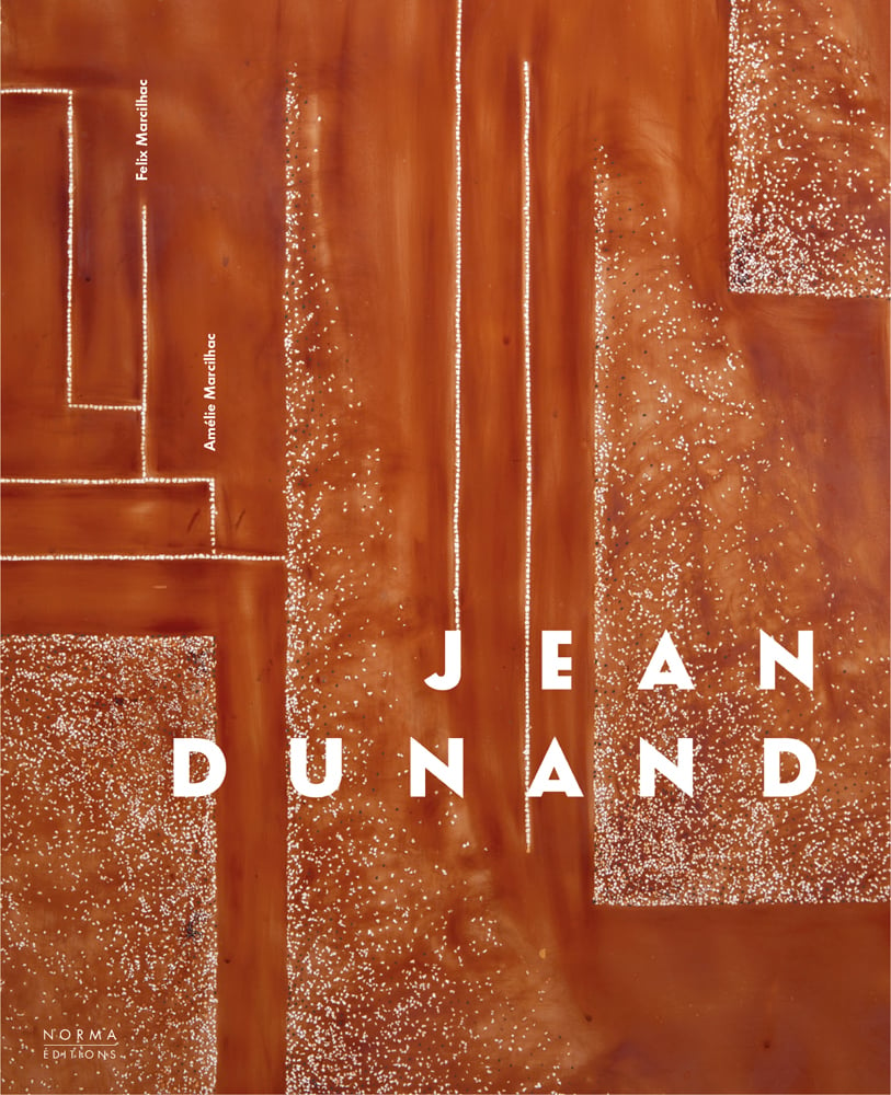 Burnt orange lacquered surface, small white decorative patterns, Jean Dunard in white font to lower right.