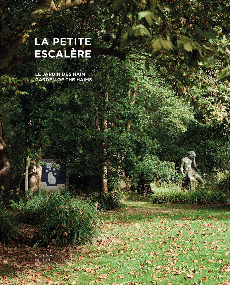 Sculpture of male figure with hand on face, surrounded by green garden foliage, on cover of 'La Petite Escalère, Garden of the Haims', by Editions Norma.