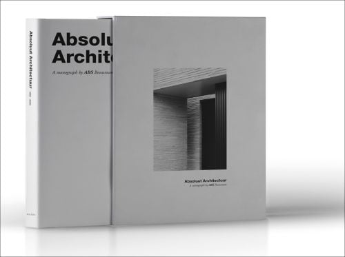 ABSOLUTE ARCHITECTURE in black font to top of white cover, in box set, photo of grey interior wall to centre.
