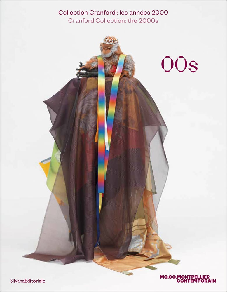 Book cover of 00s: Cranford Collection: The 2000s, with a toy orangutan wearing crown, sitting on plinth draped in colourful fabric. Published by Silvana.