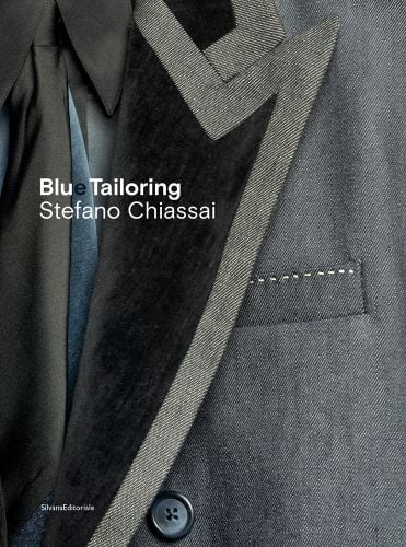 Close up shot of left lapel and collar of blue and black denim jacket, Blue Tailoring Stefano Chassai in white and blue font to left edge.