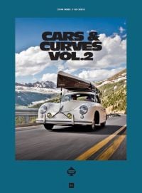 Cream Porsche 356 with small boat on roof rack traveling on road with mountains behind, on cover of 'Cars & Curves Vol.2', by Delius Klasing Verlag GmbH.