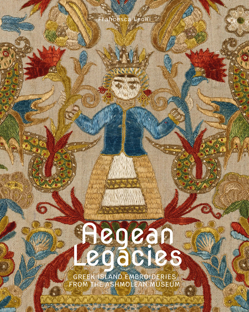 Vibrant Greek embroidery of figure wearing gold crown surrounded by flowers, on cover of 'Aegean Legacies, Greek Island Embroideries from the Ashmolean Museum', by Hali Publications.