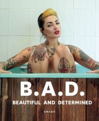 White tattooed model sitting in bathtub, on cover of 'B.A.D. Beautiful And Determined', by Drago.