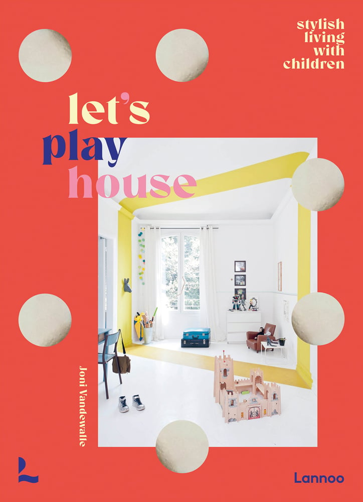 Home interior of children's play area, cardboard castle on floor, on orange cover, let’s play house in cream, blue and pink font to upper left.