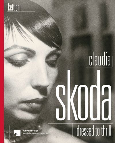 Sepia portrait of Claudia Skoda in dark make up and slick hairstyle with Claudia Skoda Dressed to Thrill in white font