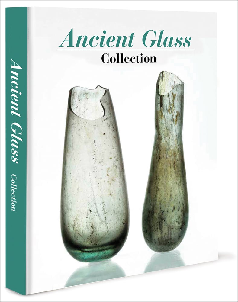 2 tall ancient glass vessels with broken top edges on white cover with Ancient Glass Collection in green and black font above