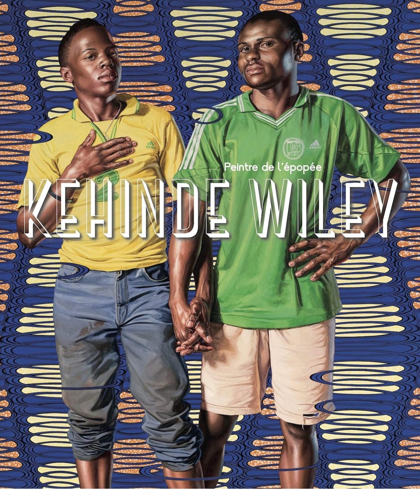 Painting of 2 black males in football shirts holding hands in front of blue and cream patterned backdrop with Kehinde Wiley in drop shadowed white font