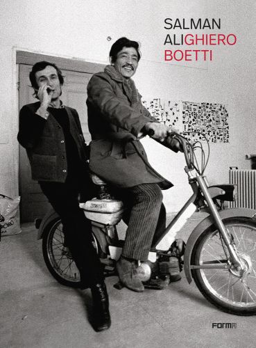 Salman Ali and Alighiero Boetti sitting on small motorcycle, on cover of 'Salman AliGhiero Boetti', by Forma Edizioni.