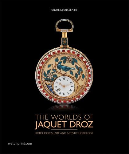 Black cover with gold pocket watch with decorative blue and beige bird painting and The Worlds of Jaquet Droz in pale gold font below