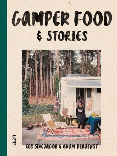 Woman sitting in doorway of campervan with black dog, in forest area, Camper Food & Stories in black font on beige cover.