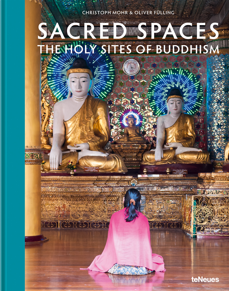 Asian female sitting before large temple statues of Buddha, SACRED SPACES THE HOLY SITES OF BUDDHISM, in white font above.