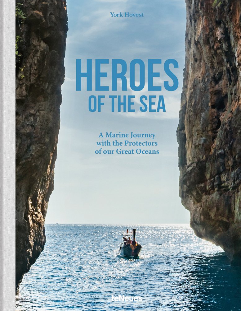 Purpose-built rowing boat on Atlantic ocean, cliffs either side, 'HEROES OF THE SEA', in pale blue font above, by teNeues Books.