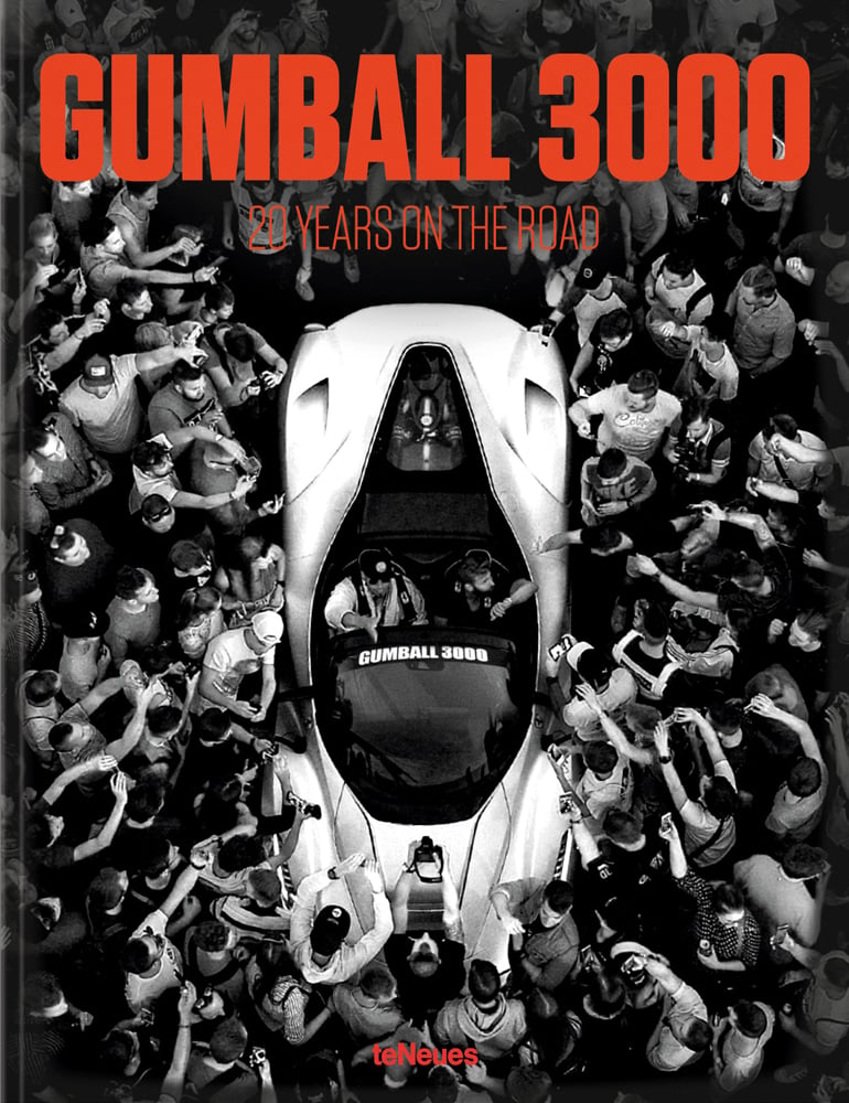 Aerial shot of supercar surrounded by crowds of people taking photographs, 'GUMBALL 3000', in red font above, by teNeues Books.