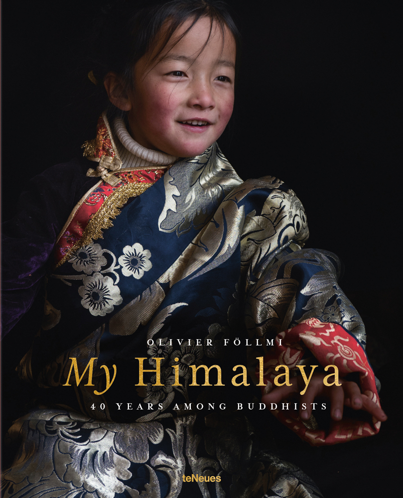 Young Himalayan child in floral robe, smiling to her left, 'My Himalaya', in gold font below, by teNeues Books.