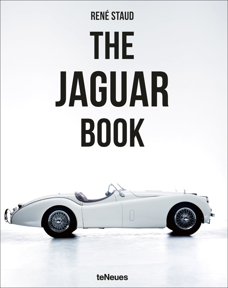 White cover with white Jaguar classic sports car with spoke wheels and The Jaguar Book in black font above