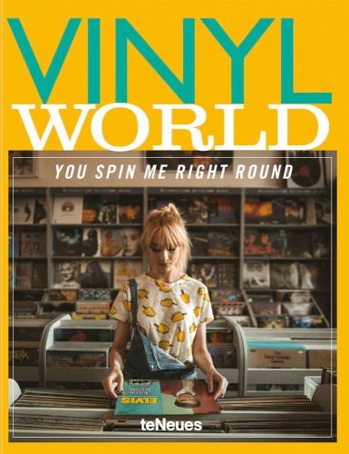 Girl standing at shelving unit full of vinyl records holding Elvis Presley record with Vinyl World in green and white font above