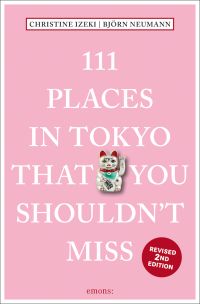 Maneki-neko or beckoning cat near center of baby pink cover of '111 Places in Tokyo That You Shouldn't Miss', by Emons Verlag.