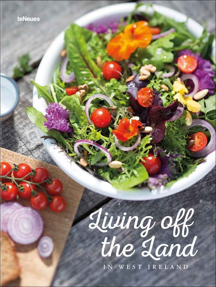 Bowl of salad with rocket, cherry tomatoes and red onion, 'Living Off the Land', in white font to bottom right of cover.