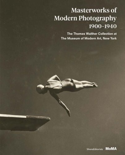 Sepia image of female swimmer in air mid diving pose with Masterworks of Modern Photography 1900-1940 in white font above