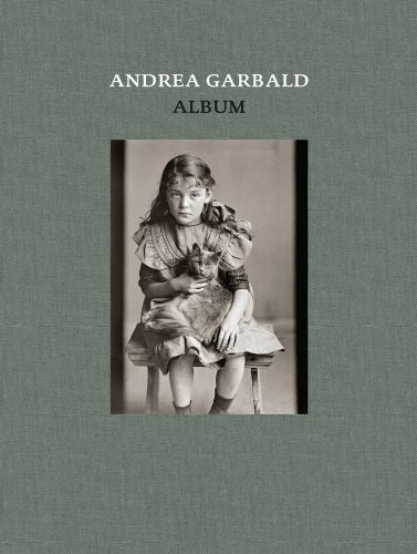 Olive green cover with young girl sitting on chair with cat in lap and Andrea Garbald Album in white and black font above