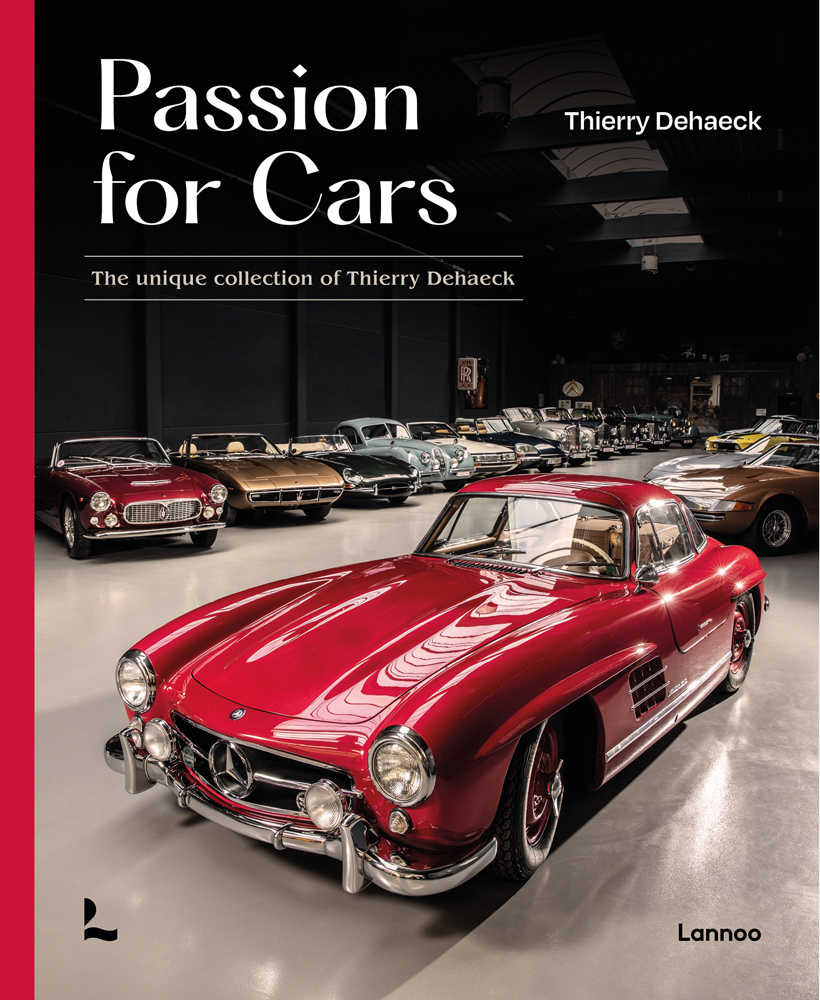Warehouse with cherry red Mercedes 300SL gullwing model standing in front of classic cars and Passion for Cars in white font