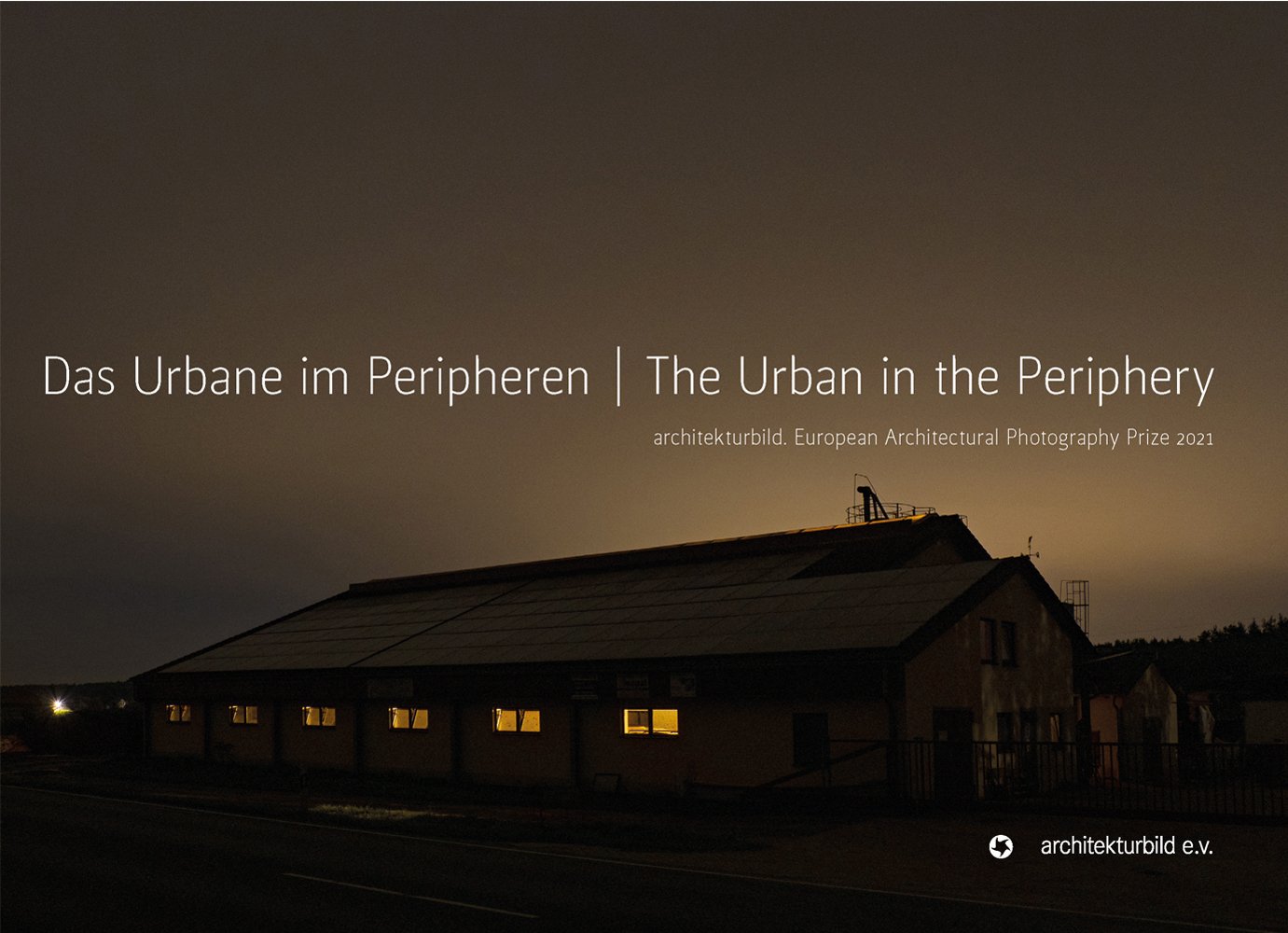 Long building with illuminated windows, under dark moody sky, on cover of 'The Urban in the Periphery, European Architectural Photography Prize 2021', by Avedition Gmbh.