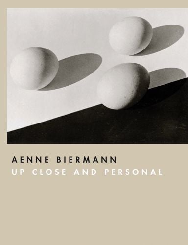Beige cover with black and white photo of 3 egg shapes with shadows and Aenne Biermann Up Close and Personal in black and white font below