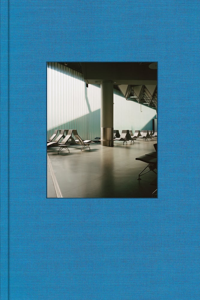 Blue cover with colour photo of deserted Frankfurt airport lounge with empty seats