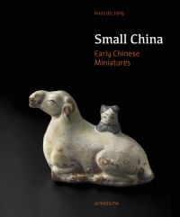 Miniature ceramic cow, Chinese figure leaning on opposite side, on black cover of 'Small China, Early Chinese Miniatures', by Arnoldsche Art Publishers.