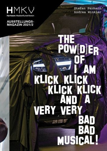 Nose of SUV with light on, covered in dark fabric and Stefan Panhans / Andrea Winkler: The Pow(d)er of I Am Klick Klick Klick Klick and a very very bad bad musical! in white font
