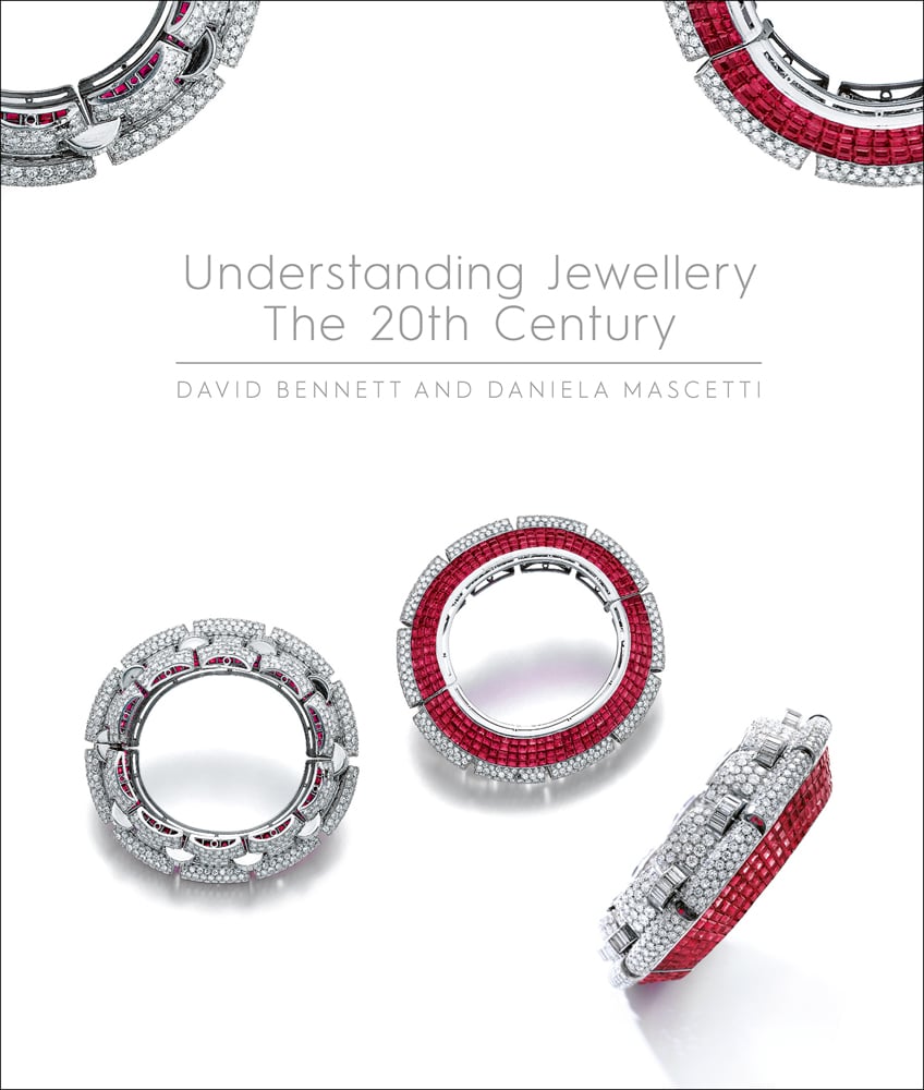 Luxury diamond and ruby jewelled bangles, on white cover of 'Understanding Jewellery, The 20th Century', by ACC Art Books.