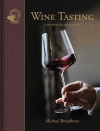 Book cover of Wine Tasting, with a hand gently swirling a glass of red wine. Published by Academie du Vin Library.