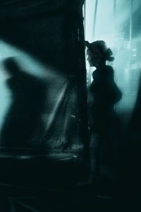 Book cover of Circus Noir, with a blurred atmospheric shot of circus performer waiting in the wings. Published by Verlag Kettler.