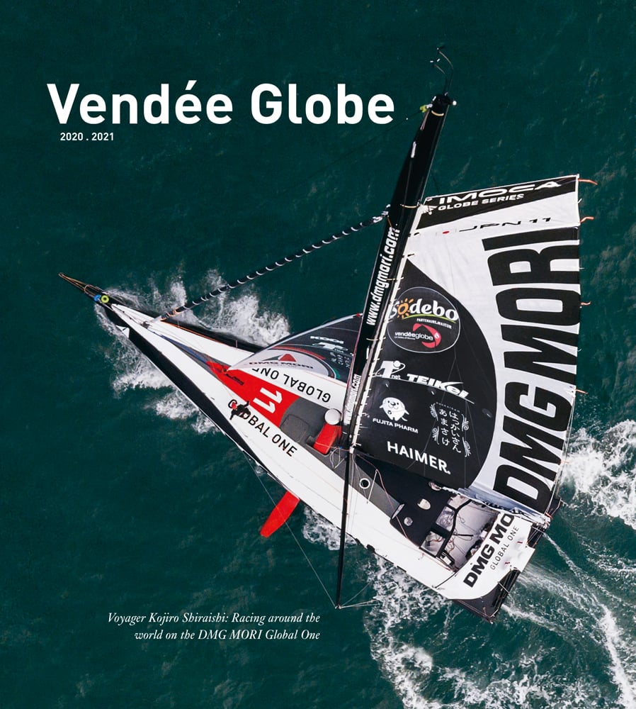 Dramatic birds eye view of DMG MORI Global One racing boat sailing through ocean with Vendée Globe 2020.2021 in white font above