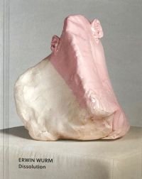 Deformed head like sculpture with ears glazed in white and pink sitting on fabric covered box, on cover of 'Erwin Wurm, Dissolution', by Arnoldsche Art Publishers.