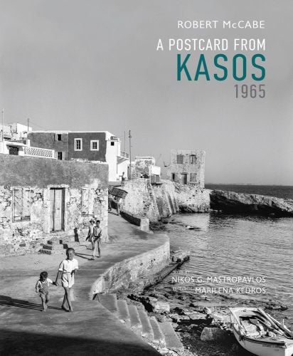 Book cover of Robert A. McCabe A Postcard from Kasos, 1965, featuring Kasos coastal area, with people walking down path next to stone buildings. Published by Abbeville Press.