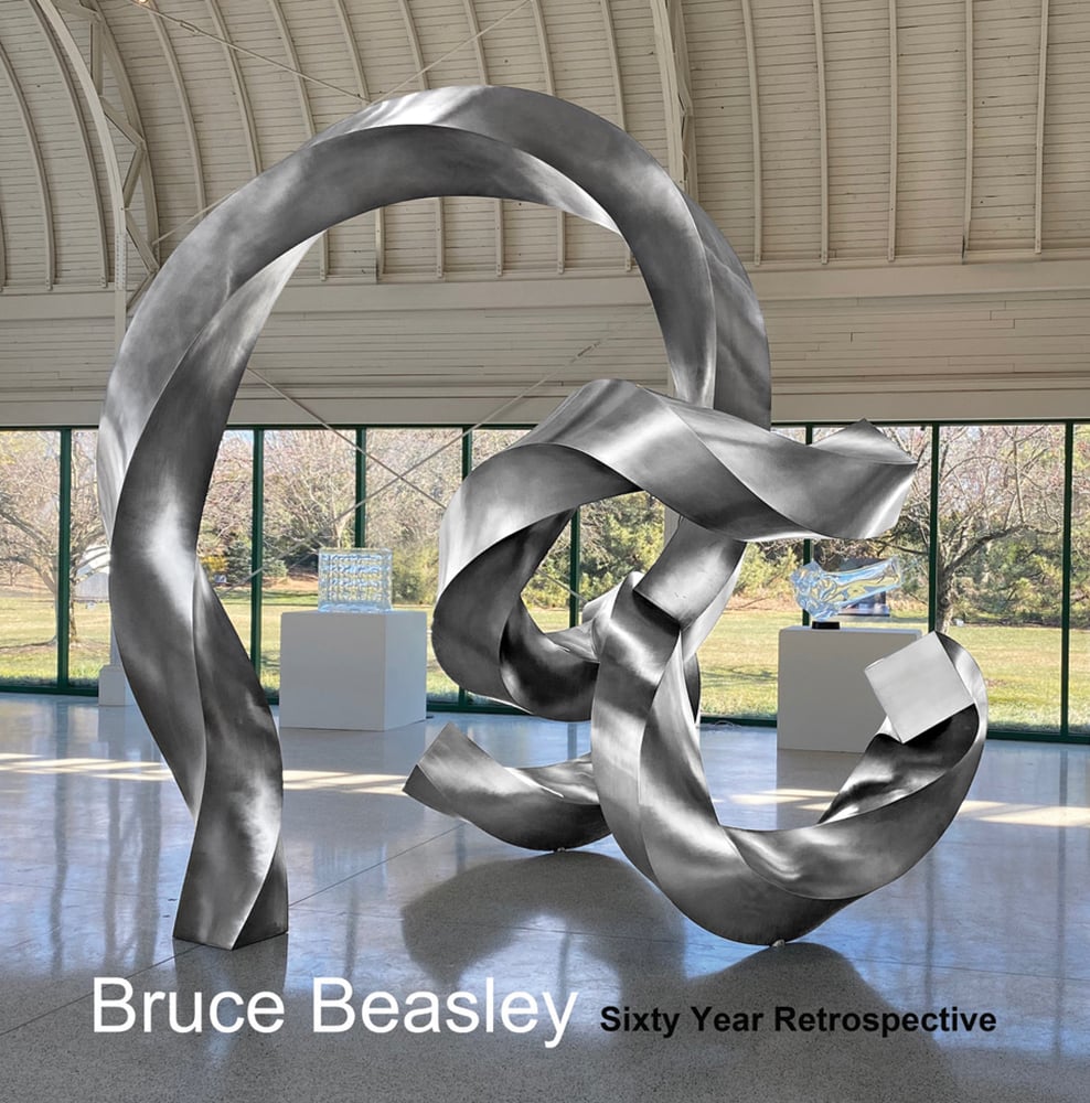 Large silver twisted sculpture in exhibition space, Bruce Beasley Sixty Year Retrospective in white and black font below