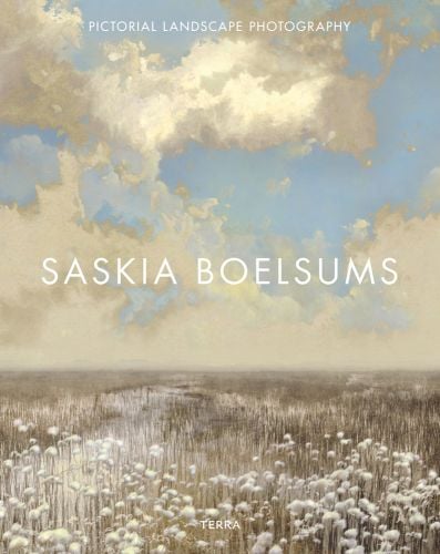 Painterly landscape of cloudy blue sky with tall white headed plants, obscuring river, on cover of 'Pictorial Landscape Photography, Saskia Boelsums', by Lanno Publishers.
