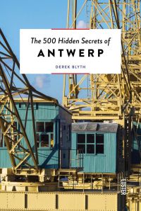 Large yellow steel structure towering over green wooden outhouses with The 500 Hidden Secrets of Antwerp in black font on a white banner