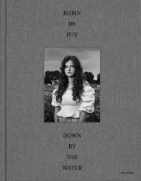Half length portrait of long haired girl in white bardot top, on grey cover, ROBIN DE PUY DOWN BY THE WATER in black font