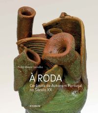 Terracotta and green ceramic sculpture of human heart on off white cover with À Roda in white font