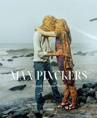 Photo of two standing human figures one with headscarf covering both heads; in front of rough seascape with Max Pinckers in white font