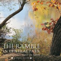 Book cover of The Ramble in Central Park A Wilderness West of Fifth, with autumn leaved trees hanging over Central Park lake. Published by Abbeville Press.