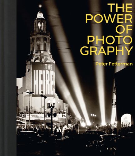 Black and white photograph of an architectural theatre at night with ground studio spotlights lighting up a full car park and queuing crowd with The Power of Photography Peter Fetterman in grey and white by ACC Art Books