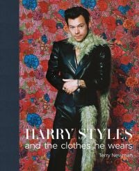 Harry Styles in black leather look suit, beige fur boa in front of vibrant pink and blue floral backdrop, Harry Styles and the clothes he wears in white font below, left navy border.