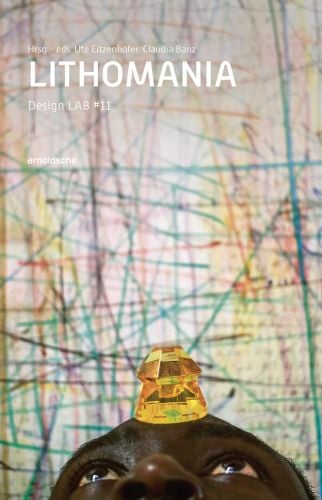 Amber jewel balancing on black skinned head, on blurred coloured pen scribbled cover, LithoMania in white above